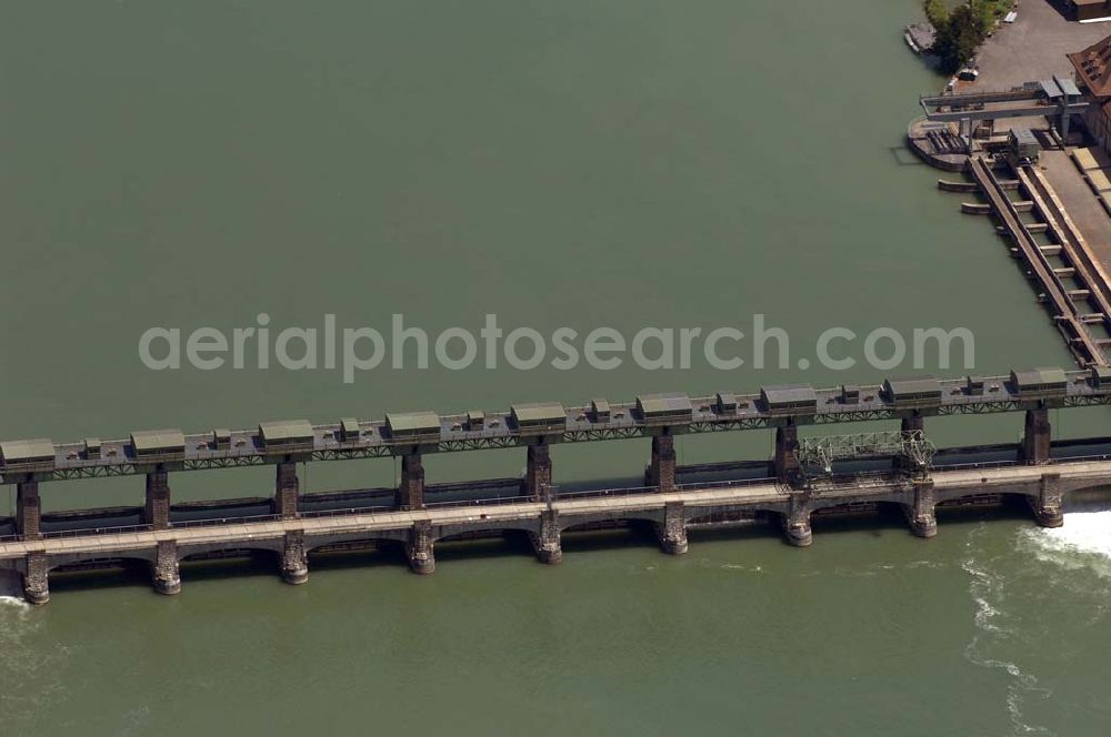 BASEL from above - Die Rechenreinigungsmaschine entfernt das Schwemmgut des Rheins vom Rechen und sorgt so für einen freien Wasserzufluss zu den Turbinen. Homepage Kraftwerk Augst: http://