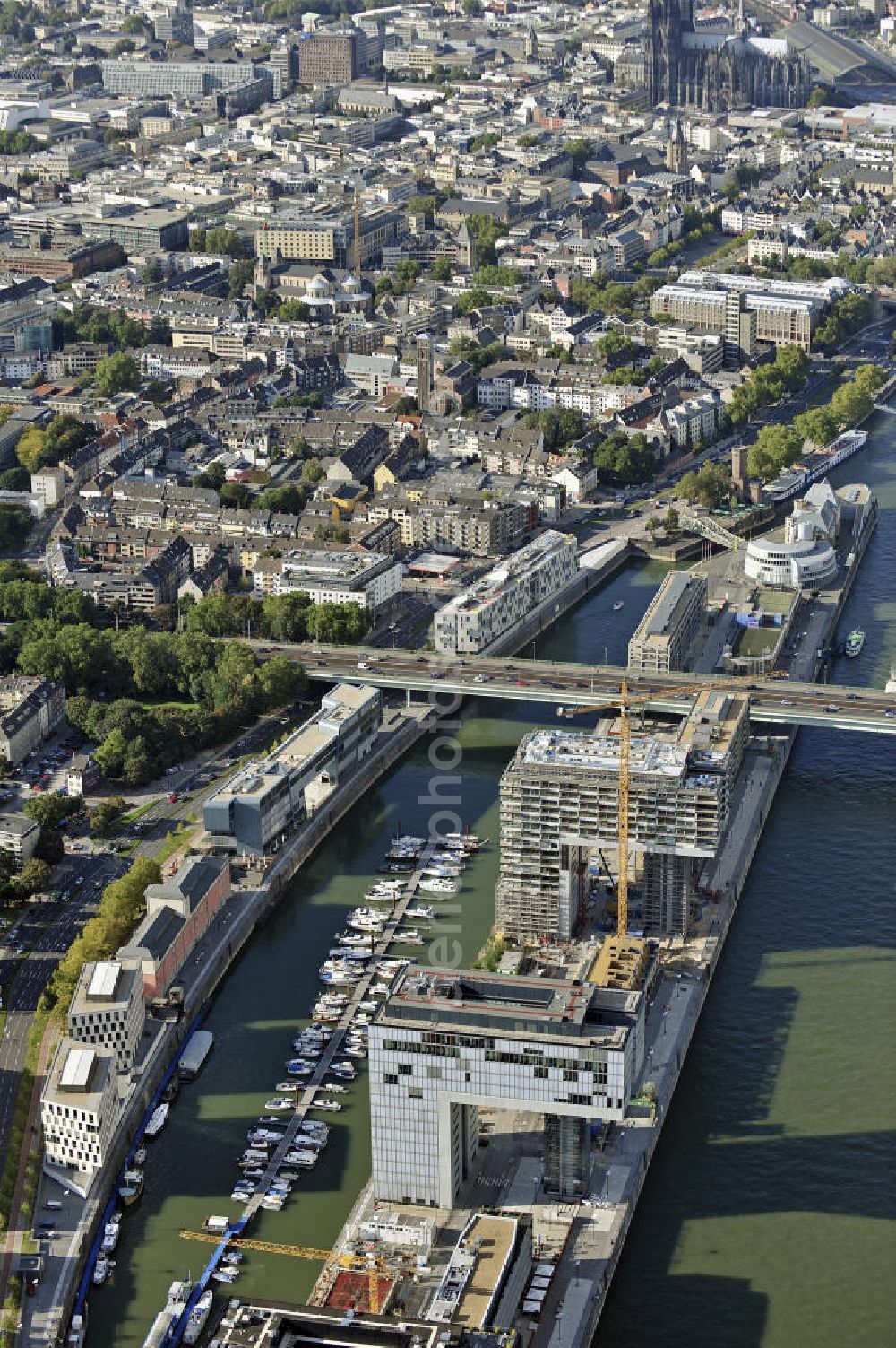 Köln from above - Blick auf die Baustelle der Kranhäuser am Kölner Rheinauhafen. Die Bürogebäude sind alle ca. 60 Meter hoch, 34 Meter breit und haben eine Länge von 70 Metern. Entworfen wurden sie vom Architekturbüro BRT Bothe Richter Teherani. View of the construction site of the Kran Houses on Rheinauhafen. The office buildings are all about 60 feet high, 34 meters wide and have a length of 70 meters. They were designed by architects BRT Bothe Richter Teherani.