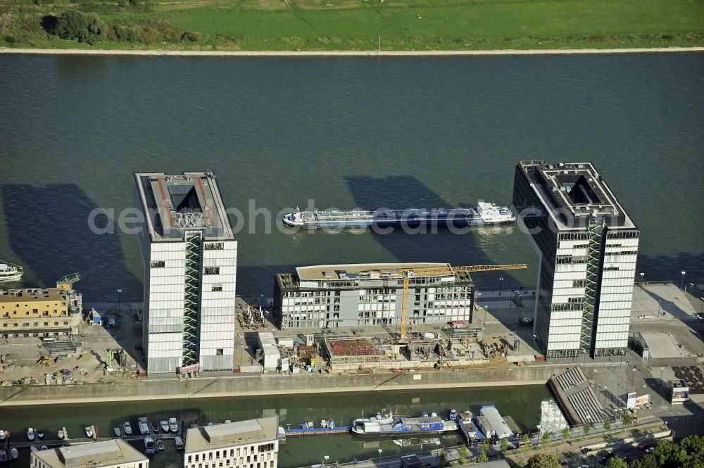 Aerial photograph Köln - Blick auf die Baustelle der Kranhäuser am Kölner Rheinauhafen. Die Bürogebäude sind alle ca. 60 Meter hoch, 34 Meter breit und haben eine Länge von 70 Metern. Entworfen wurden sie vom Architekturbüro BRT Bothe Richter Teherani. View of the construction site of the Kran Houses on Rheinauhafen. The office buildings are all about 60 feet high, 34 meters wide and have a length of 70 meters. They were designed by architects BRT Bothe Richter Teherani.