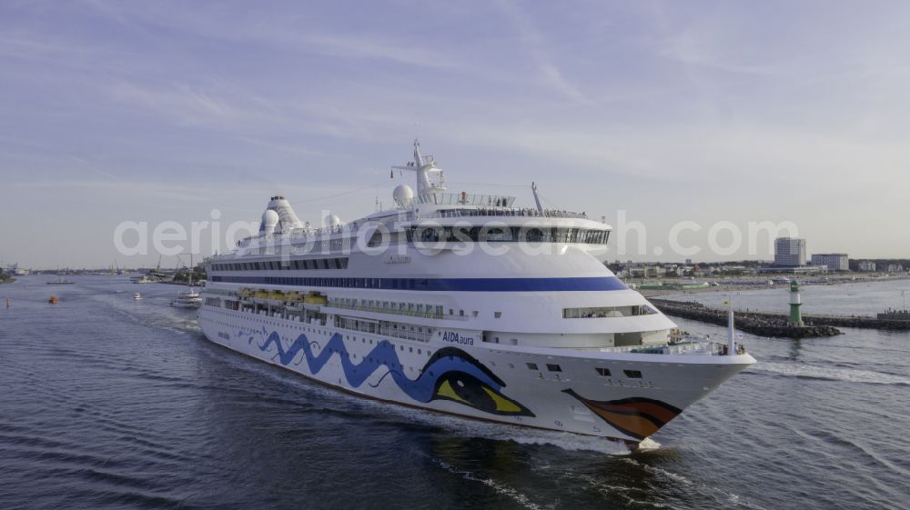 Aerial photograph Rostock - Cruise and passenger ship AidaAura in mission of baltic sea in the district Warnemuende in Rostock at the baltic sea coast in the state Mecklenburg - Western Pomerania, Germany