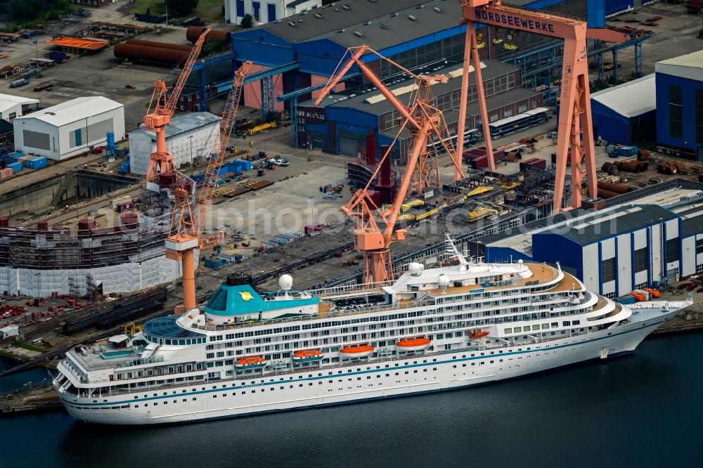 Aerial image Emden - Cruise and passenger ship Amera on dock in Emden in the state Lower Saxony, Germany