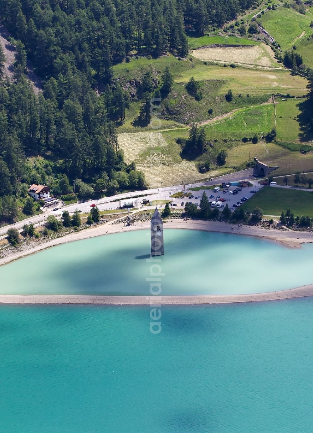Graun Im Vinschgau from the bird's eye view: View of the church steeple Alt-Graun in Vinschgau in Italy. At the beginning of the 20th century, all of the buildings in Alt-Graun were blown up, so the area could be used as a reservoir