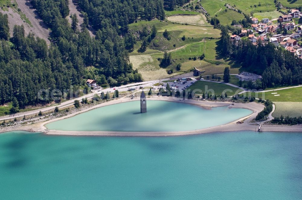 Aerial image Graun Im Vinschgau - View of the church steeple Alt-Graun in Vinschgau in Italy. At the beginning of the 20th century, all of the buildings in Alt-Graun were blown up, so the area could be used as a reservoir