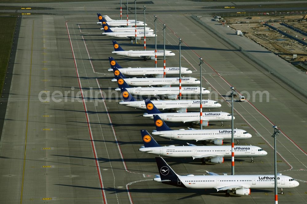 Schönefeld from above - Decommissioned due to crisis passenger airplanes of the airline Lufthansa in parking position - parking area at the airport in Schoenefeld in the state Brandenburg, Germany