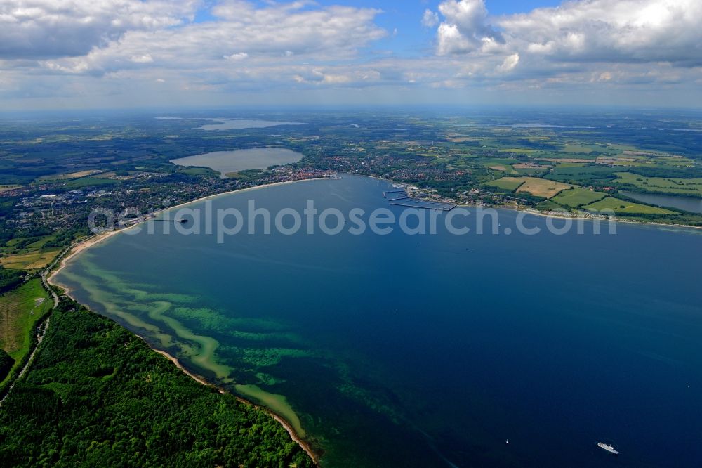 Aerial photograph Altenhof - Coastline on the sandy beach of the baltic sea and the city Eckernfoerde with surrounding lakes, fields and forestland in Altenhof in the state Schleswig-Holstein