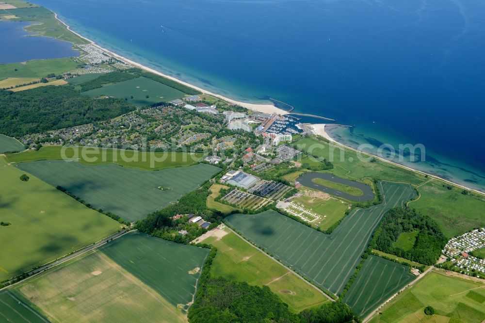 Damp from above - Coastline on the sandy beach of the baltic sea and the local community Damp with fields in the state Schleswig-Holstein