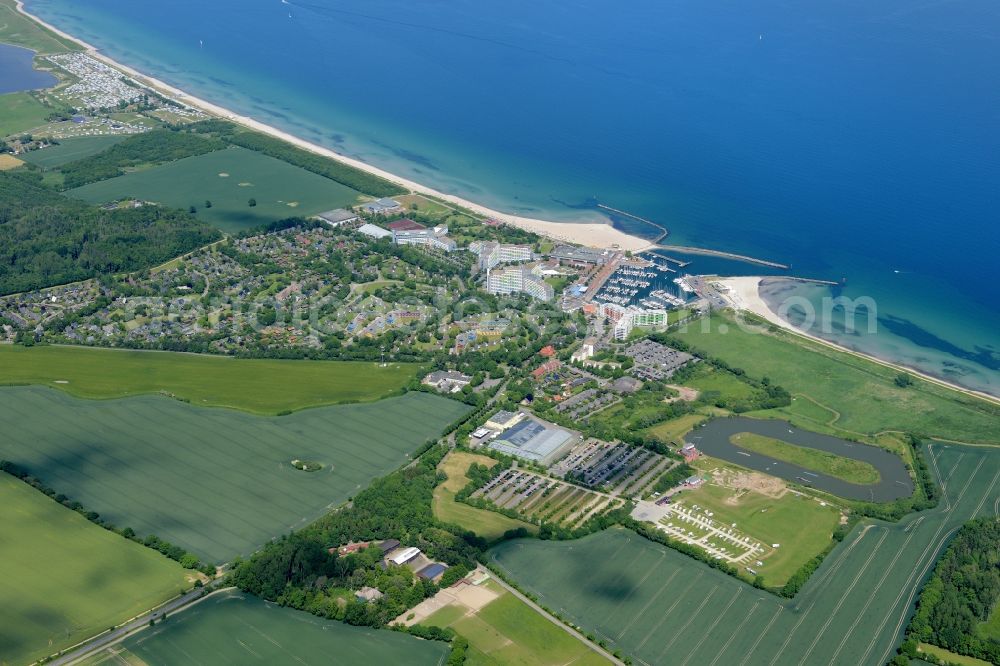 Damp from the bird's eye view: Coastline on the sandy beach of the baltic sea and the local community Damp with fields in the state Schleswig-Holstein