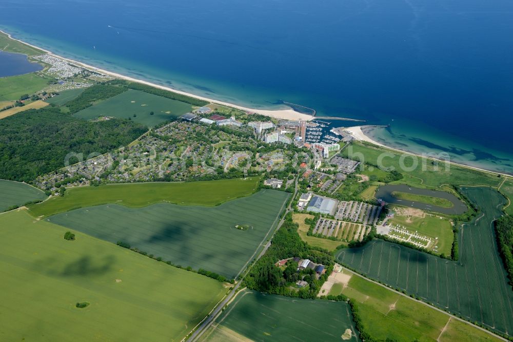 Damp from above - Coastline on the sandy beach of the baltic sea and the local community Damp with fields in the state Schleswig-Holstein