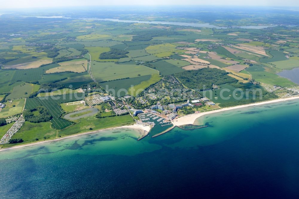 Damp from the bird's eye view: Coastline on the sandy beach of the baltic sea and the local community Damp with fields in the state Schleswig-Holstein