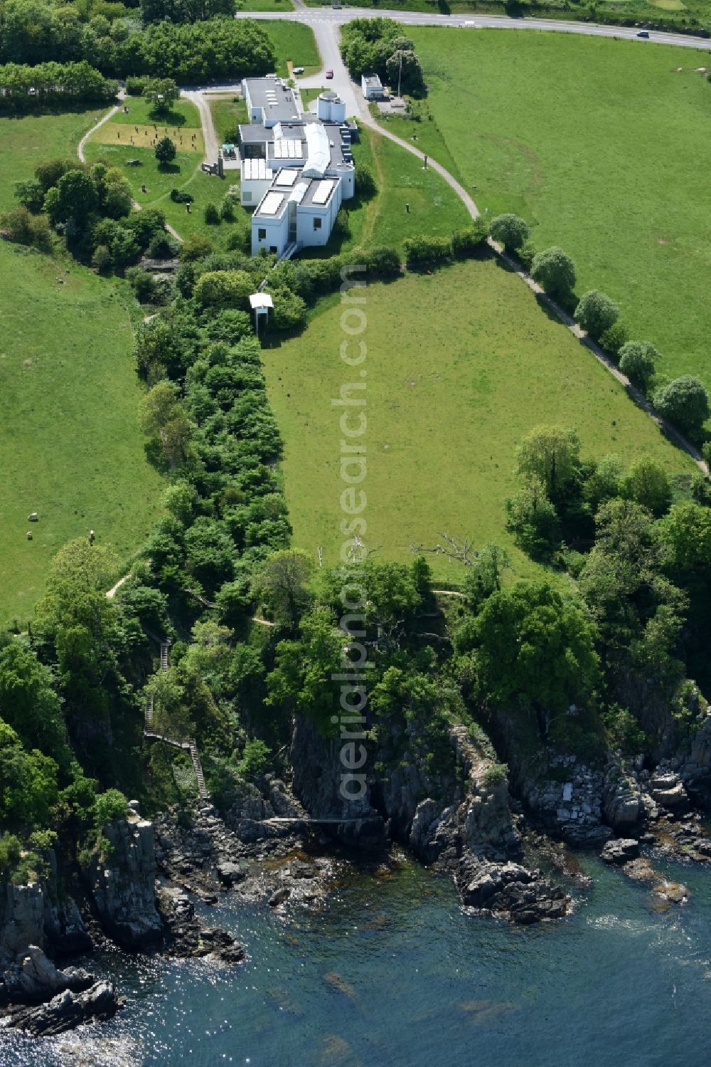 Gudhjem from above - Coastline at the rocky cliffs Helligdomsklipperne of Baltic Sea on Bornholm Island in Gudhjem in Region Hovedstaden, Denmark