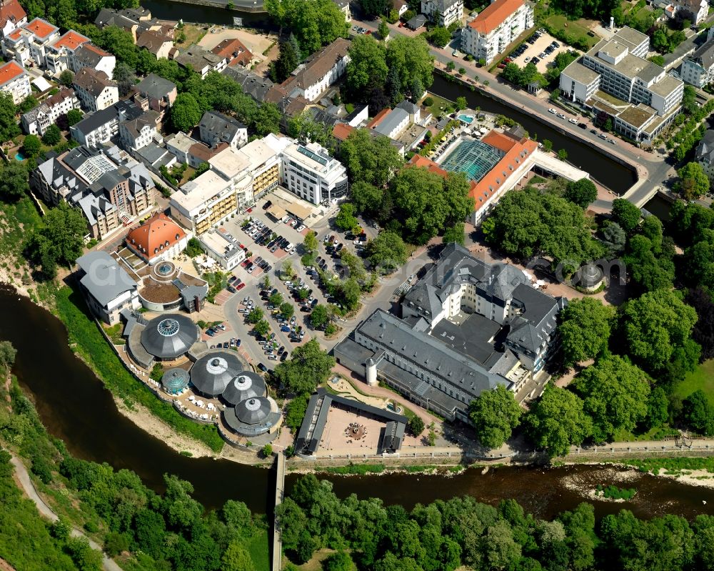 Bad Kreuznach from above - Spa and spa gardens of Bad Kreuznach in the state of Rhineland-Palatinate. Bad Kreuznach is a spa town and county capital and is located on the rivers Nahe and Ellerbach. Apart from historic buildings and parts of the town, there are also several residential areas with multi-family homes and estates. The facilities of the spa and resorts such as the Crucenia spa and Baths are located on the right riverbank of the Nahe, in the West of the town centre