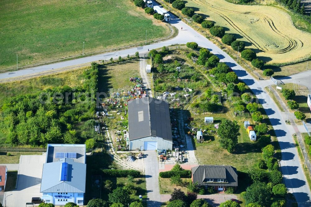 Aerial photograph Woldegk - Bearing surface fuer discarded toy vending machines and driving machines on Muehlenblick corner Muehlengrandstrasse in the industrial area in Woldegk in the state Mecklenburg - Western Pomerania, Germany