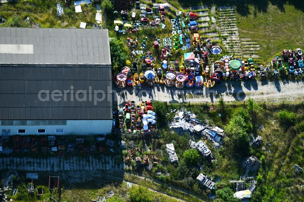 Woldegk from the bird's eye view: Bearing surface fuer discarded toy vending machines and driving machines on Muehlenblick corner Muehlengrandstrasse in the industrial area in Woldegk in the state Mecklenburg - Western Pomerania, Germany