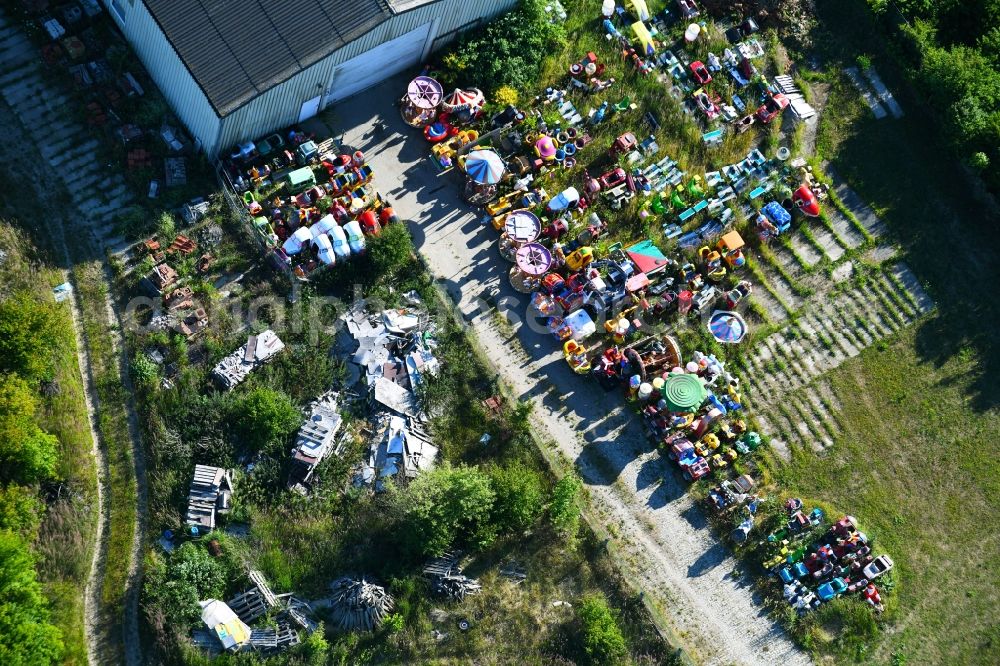 Woldegk from the bird's eye view: Bearing surface fuer discarded toy vending machines and driving machines on Muehlenblick corner Muehlengrandstrasse in the industrial area in Woldegk in the state Mecklenburg - Western Pomerania, Germany