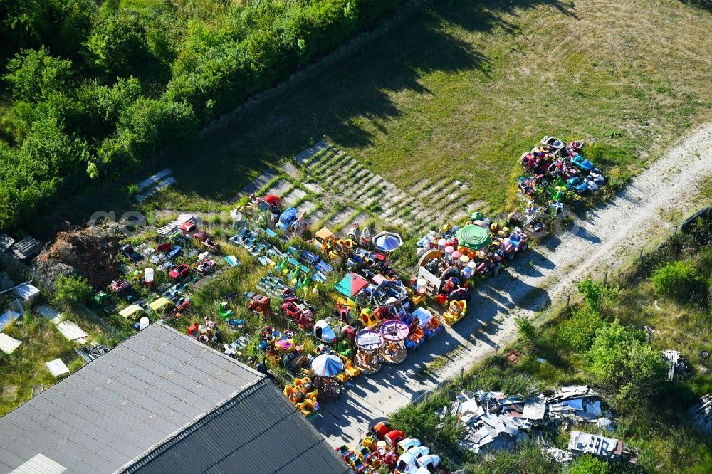 Woldegk from the bird's eye view: Bearing surface fuer discarded toy vending machines and driving machines on Muehlenblick corner Muehlengrandstrasse in the industrial area in Woldegk in the state Mecklenburg - Western Pomerania, Germany