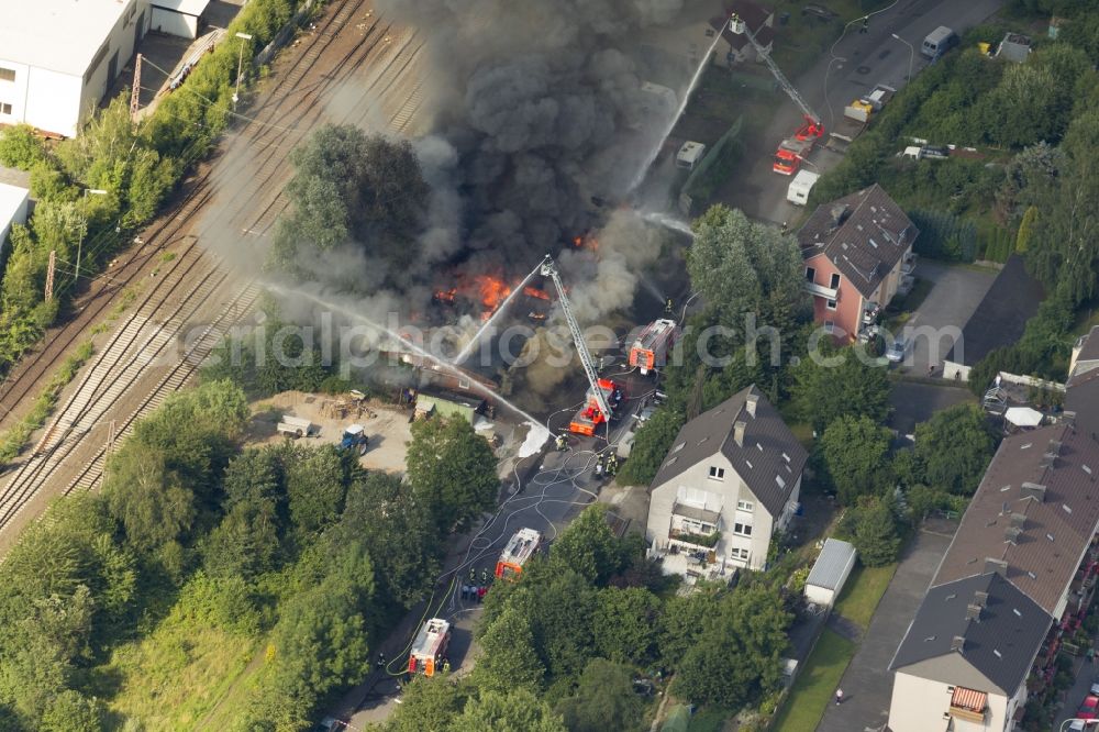 Hagen from the bird's eye view: The fire extinguishing work on a destroyed by the fire warehouse in Hagen in North Rhine-Westphalia