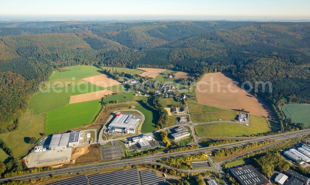 Meschede from the bird's eye view: Warehouse complex-building in the industrial area Enste Nord an der A 46 in Meschede in the state North Rhine-Westphalia, Germany with settlements of the Companies EVENTTECHNIK SUeDWESTFALEN, ITH GmbH & Co. KG, SH Anbaugeraete GmbH and Feuerwehrverband Hochsauerlandkreis e.V