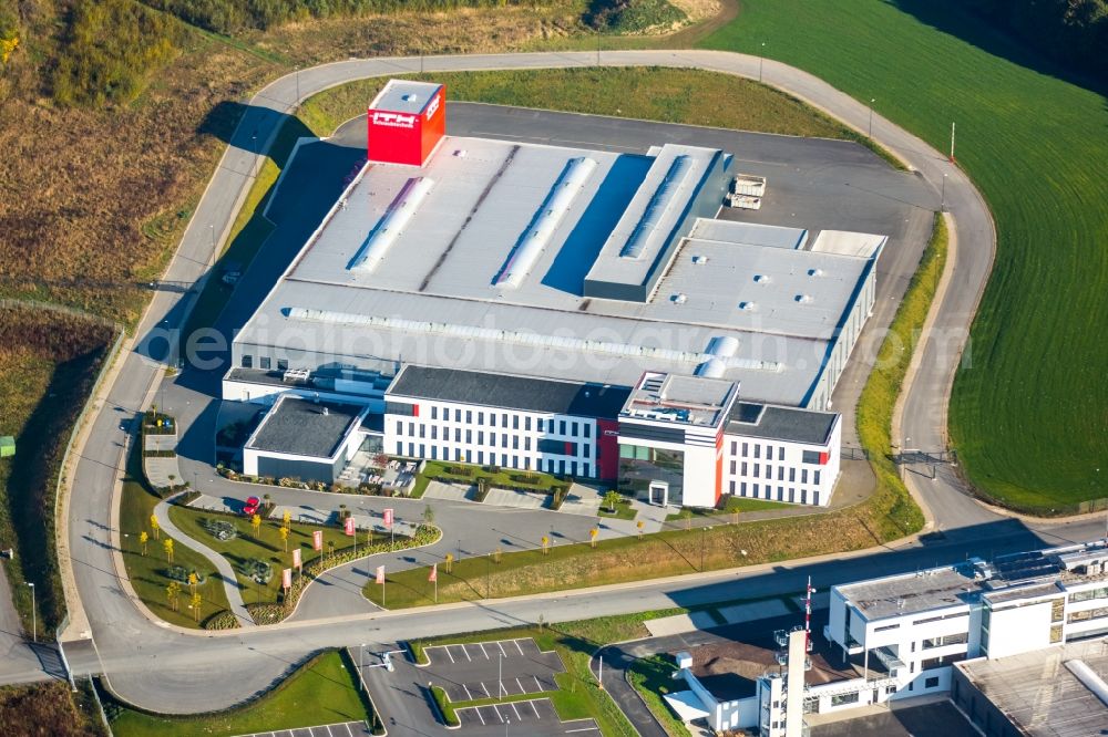 Meschede from the bird's eye view: Warehouse complex-building in the industrial area Enste Nord an der A 46 in Meschede in the state North Rhine-Westphalia, Germany with settlements of the Companies EVENTTECHNIK SUeDWESTFALEN, ITH GmbH & Co. KG, SH Anbaugeraete GmbH and Feuerwehrverband Hochsauerlandkreis e.V