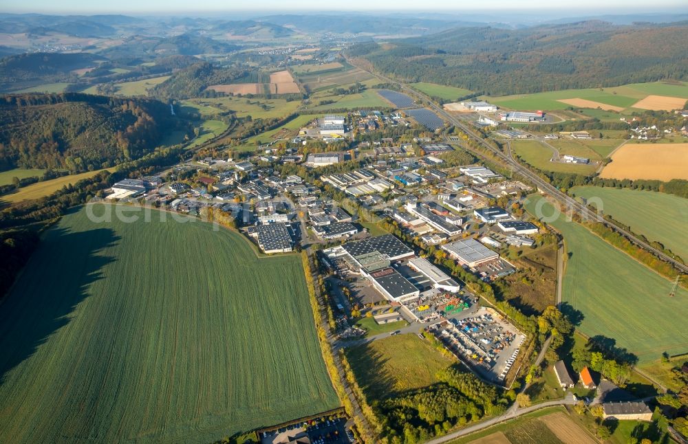 Meschede from the bird's eye view: Warehouse complex-building in the industrial area Enste Nord an der A 46 in Meschede in the state North Rhine-Westphalia, Germany with settlements of the Companies EVENTTECHNIK SUeDWESTFALEN, ITH GmbH & Co. KG, SH Anbaugeraete GmbH and Feuerwehrverband Hochsauerlandkreis e.V