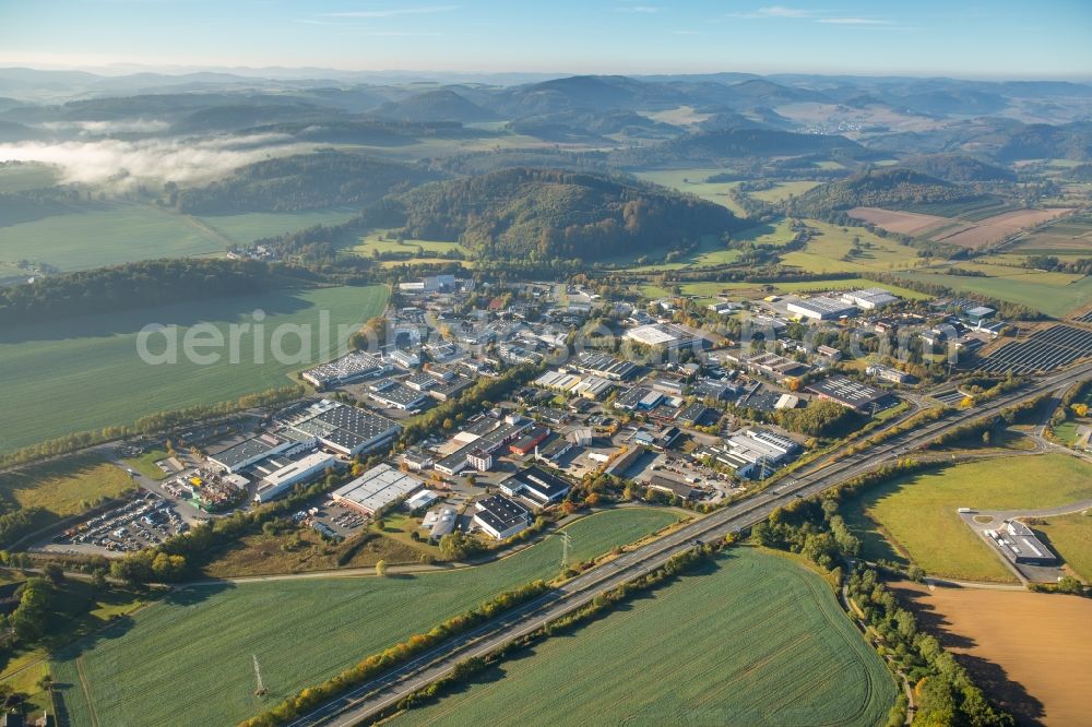 Meschede from the bird's eye view: Warehouse complex-building in the industrial area Enste Nord an der A 46 in Meschede in the state North Rhine-Westphalia, Germany with settlements of the Companies EVENTTECHNIK SUeDWESTFALEN, ITH GmbH & Co. KG, SH Anbaugeraete GmbH and Feuerwehrverband Hochsauerlandkreis e.V