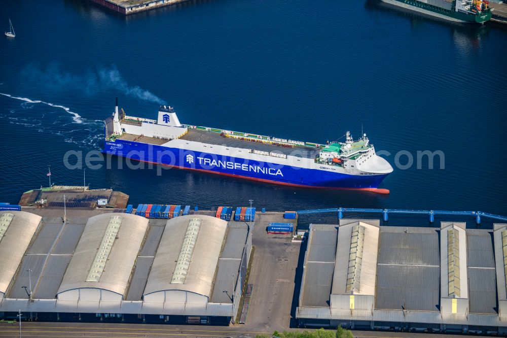 Lübeck from the bird's eye view: Warehouse complex building in the commercial area on the banks of the Trave with the car ferry Corona Sea on Fabrikstrasse in Luebeck in the state Schleswig-Holstein