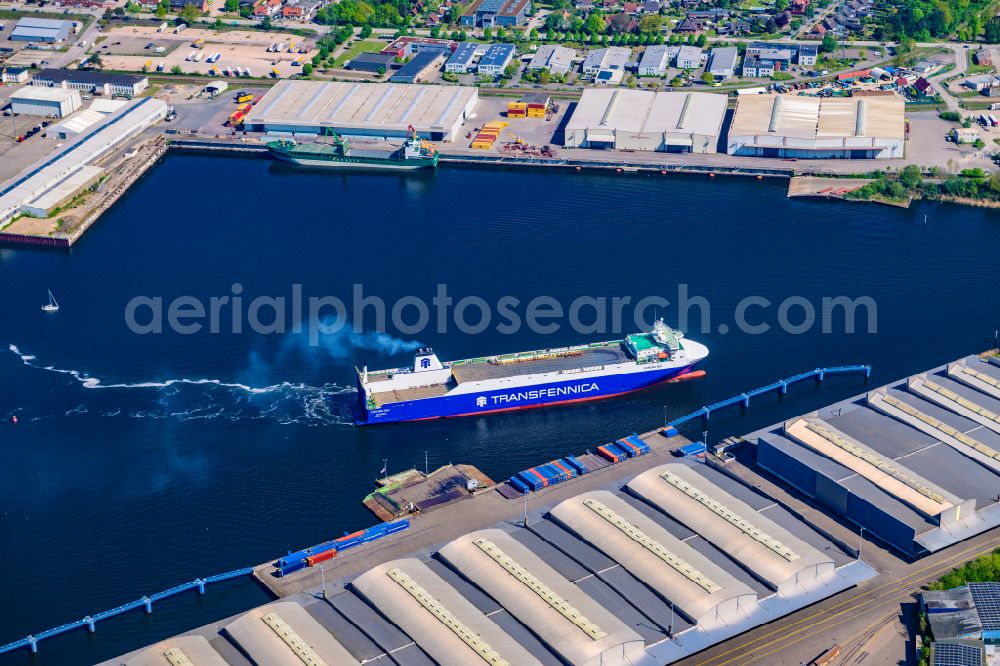 Aerial photograph Lübeck - Warehouse complex building in the commercial area on the banks of the Trave with the car ferry Corona Sea on Fabrikstrasse in Luebeck in the state Schleswig-Holstein