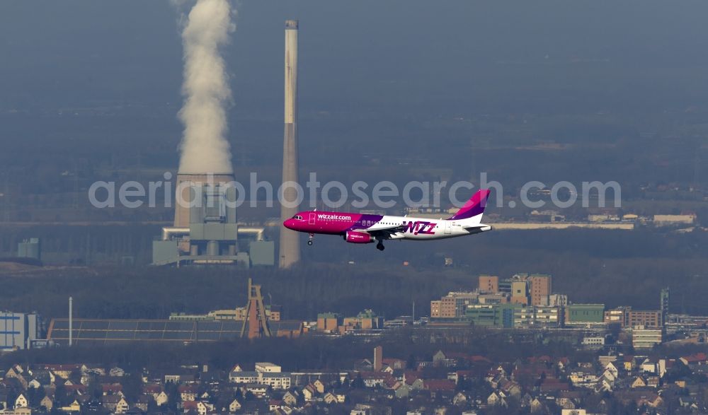 Aerial image Dortmund - Landing approach of an Airbus A320 on the runway of the airport Dortmund Wickede in North Rhine-Westphalia. The Wizz Air is a 2004 founded Ukrainian air carriers