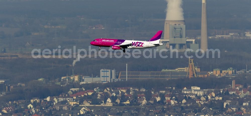 Dortmund from above - Landing approach of an Airbus A320 on the runway of the airport Dortmund Wickede in North Rhine-Westphalia. The Wizz Air is a 2004 founded Ukrainian air carriers