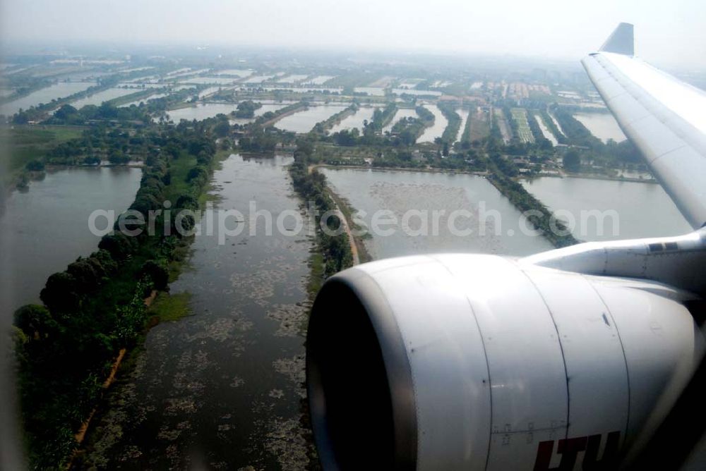 Aerial photograph Bangkok / Thailand - Landeanflug mit einem Airbus A330 der LTU auf dem Flughafen Bangkok International von Norden her über Reisanbaugebiete am Stadtrand