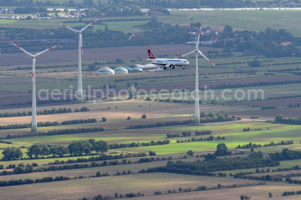 Bremen from the bird's eye view: Aircraft of Turkish Airlines with type designation A319-132/100 in flight over the airspace in Bremen near interchange Bremen-Hemelingen in Germany