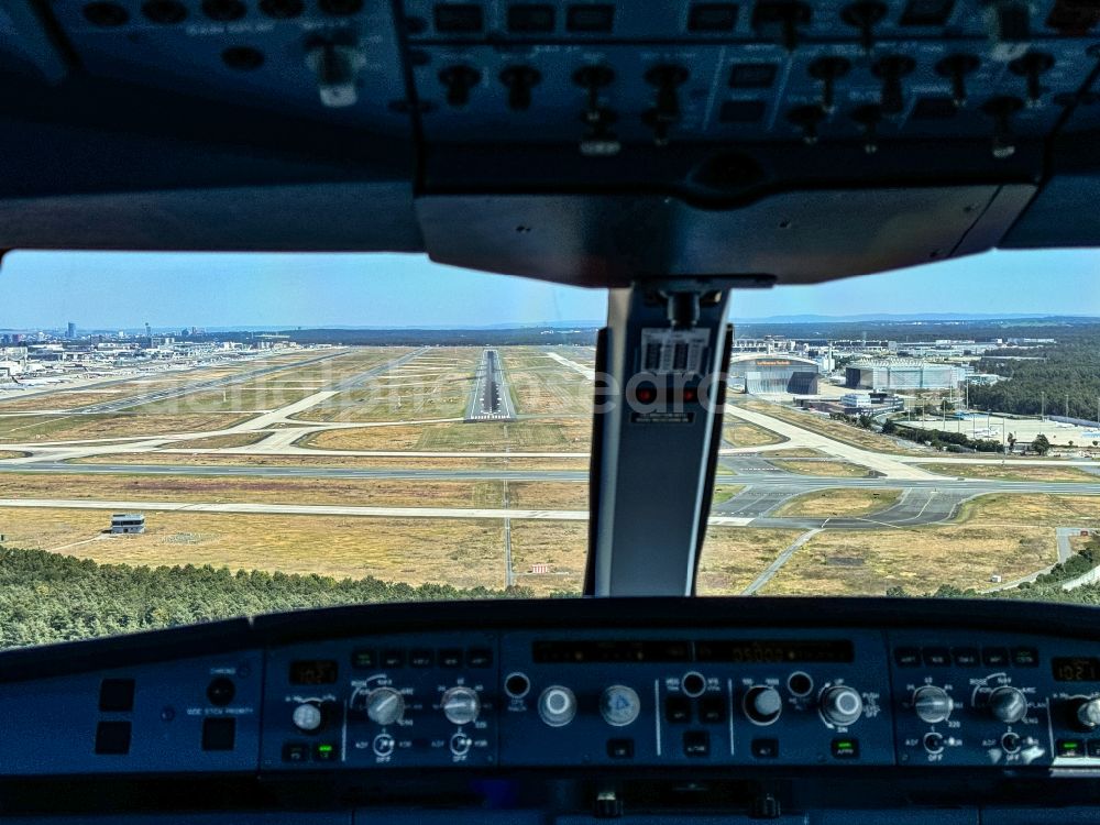 Frankfurt am Main from above - Runways with taxiways, hangars and terminals on the airport grounds at runway 07R from the cockpit of a commercial aircraft approaching the Okrifteler Strasse in Frankfurt am Main in the state of Hesse, Germany