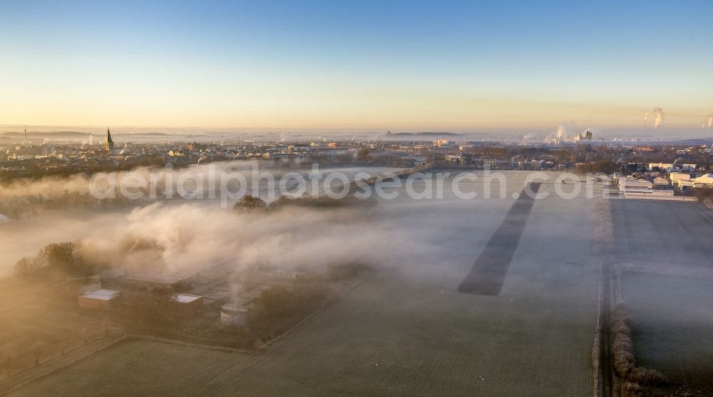 Aerial photograph Hamm - Runway 06 24 of airfield Hamm-Lippewiesen EDLH in morning fog at sunrise in Hamm, North Rhine-Westphalia