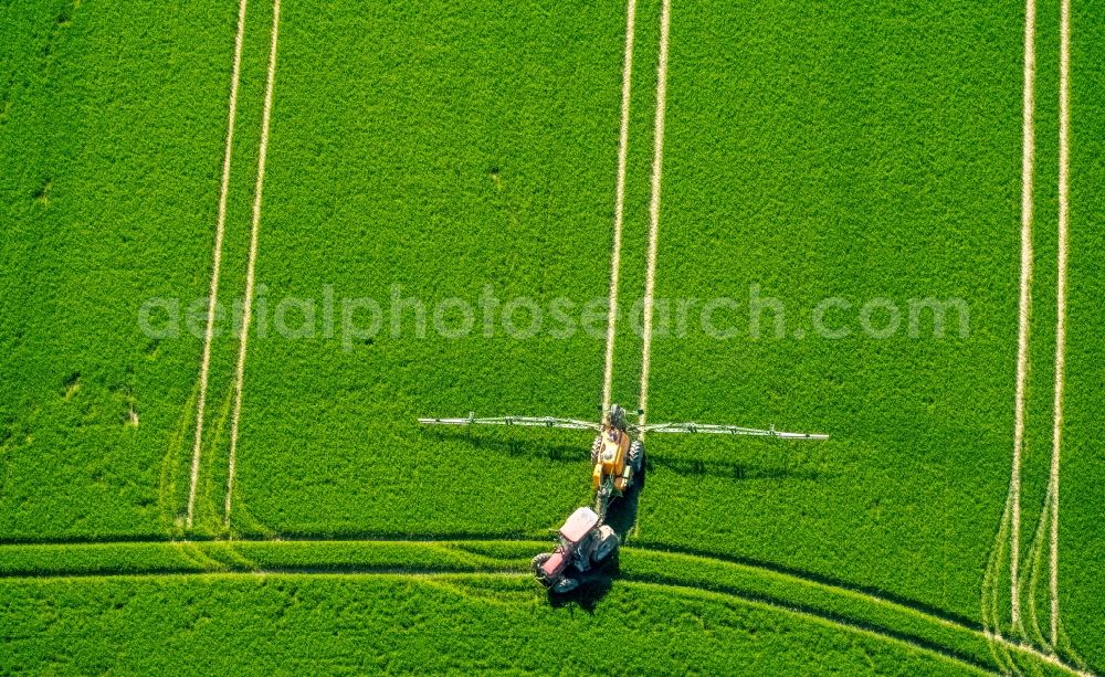 Anröchte from the bird's eye view: Farm equipment used for fertilizing fields in Anroechte in the state North Rhine-Westphalia, Germany