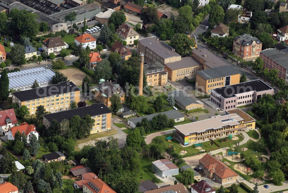 Aerial photograph Apolda - Parts of the district office Weimar are housed in the residential block-like buildings in the Louis-Opel-Straße in Apolda in Thuringia. In the building right behind the chimney is the monitoring body of the Materials Research and Testing at the Weimar Bauhaus University Weimar. The two-story colorful low-rise building in the foreground is the daycare - Rainbow House