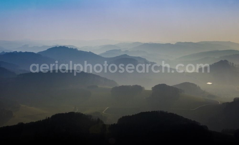 Meschede from the bird's eye view: Weather landscape over the space enclosed by clouds and haze valleys and wooded areas near Meschede in the state of North Rhine-Westphalia