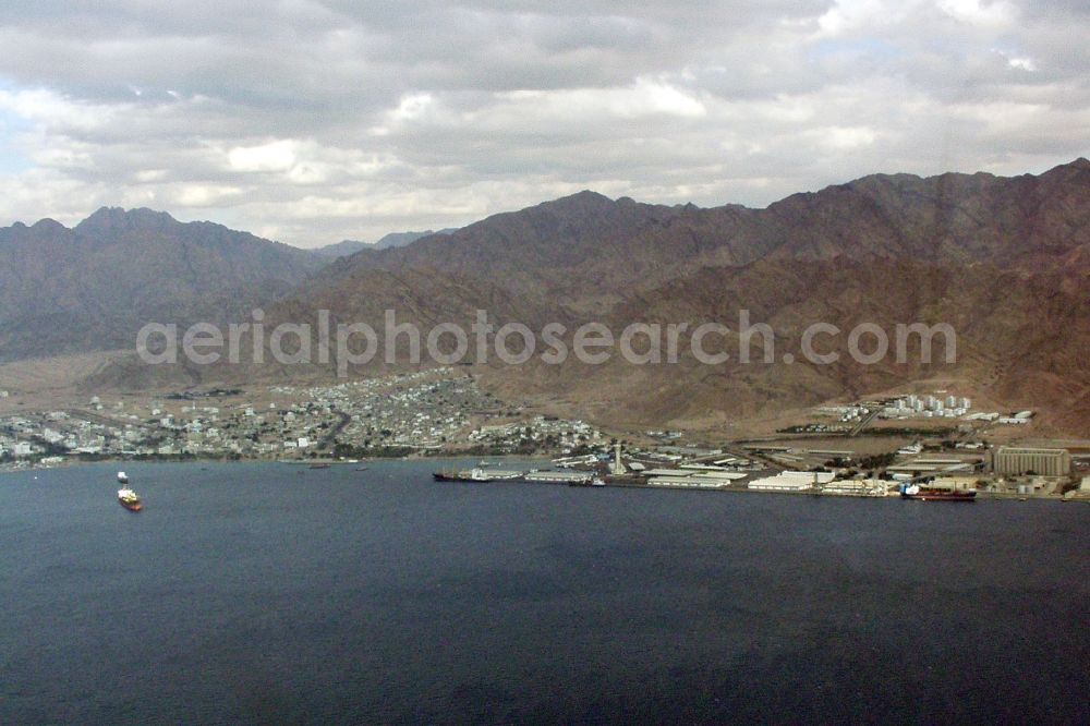 Aqaba from the bird's eye view: Port facilities, City, mountains and landscape at the seashore of the Gulf of Aqaba in Aqaba in Aqaba Governorate, Jordan