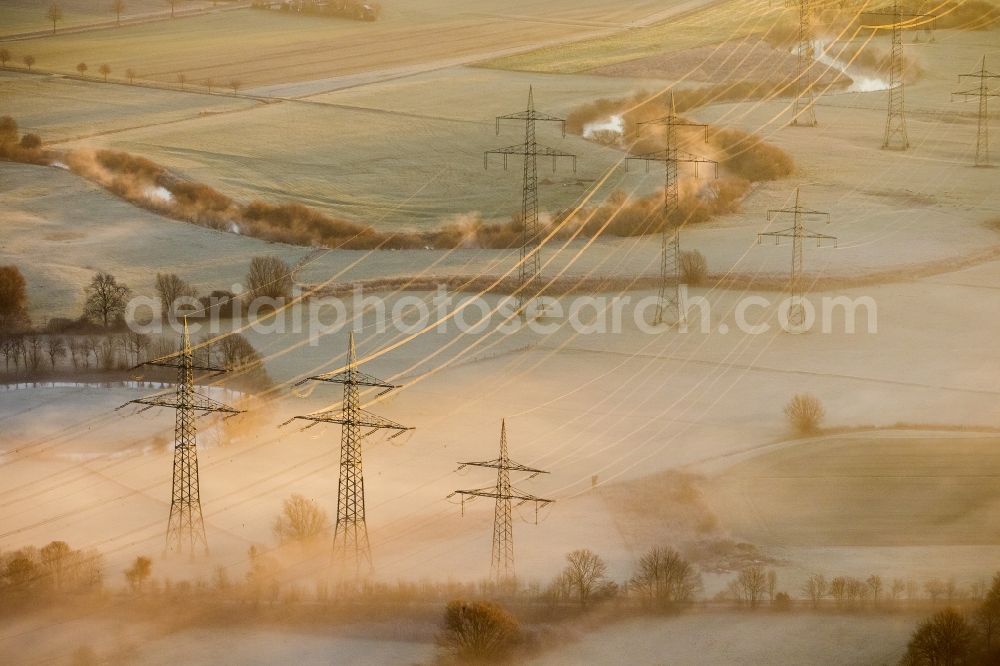 Aerial image Hamm - Landscape with morning fog over the power poles in the meadows of Lippeauen at sunrise on coal-fired power plant of RWE in the district Schmehausen of Hamm in North Rhine-Westphalia