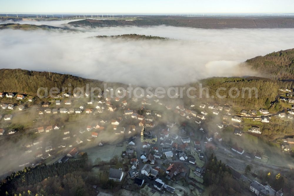 Aerial photograph Marsberg OT Padberg - From fog layer and clouds outstanding Church of St. Mary Magdalene - also Padberger Dom-in Padberg, a district of Marsberg in North Rhine-Westphalia