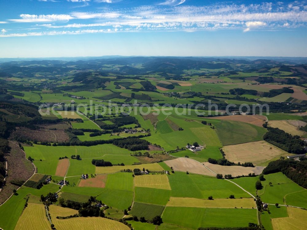 Meschede from above - Landscape of the Sauerland region in the South of Remblinghausen in Meschede in the state of North Rhine-Westphalia. The landscape is characterised by agricultural fields and the hills and forest areas of the mountain range