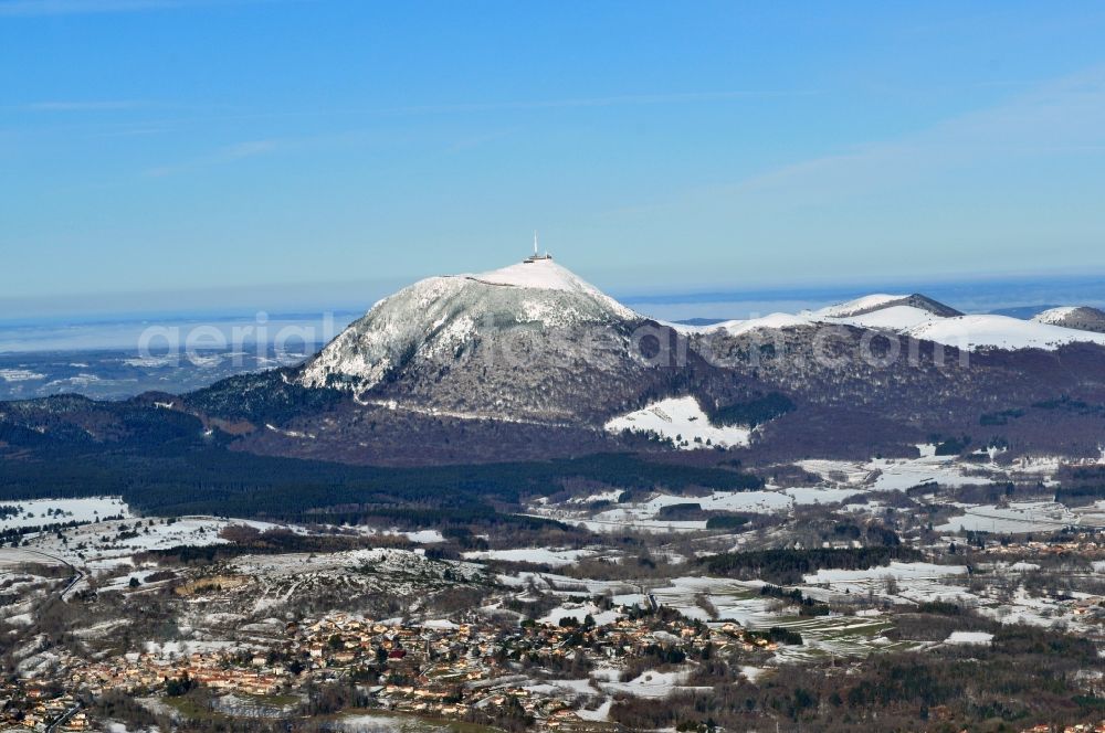 Fontanas from the bird's eye view: In veiled sunset with fog volcanic mountain Puy-de-Dome in the province of Auvergne in France