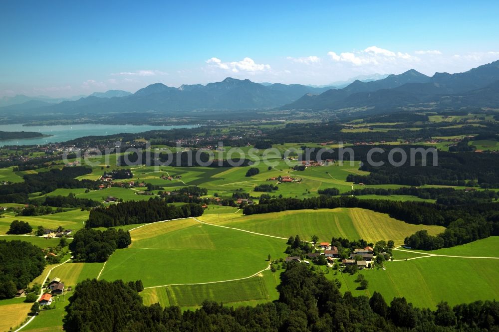 Aerial photograph Traunstein - Landscape in Traunstein in the state of Bavria. In the surrounding region of Traunstein, there are several small settlements and villages. View from Traunstein to the South where the Alps are located. The landscape is characterised by hills and valleys as well as Lake Chiemsee which can be seen here as well