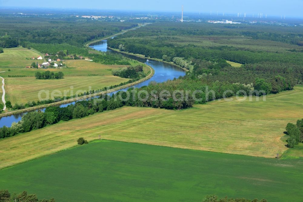 Genthin from above - Landscape on the riverbank and course of the Elbe-Havel canal in Genthin in the state of Saxony-Anhalt. The canal is surrounded by forest and fields. Genthin is located in the background