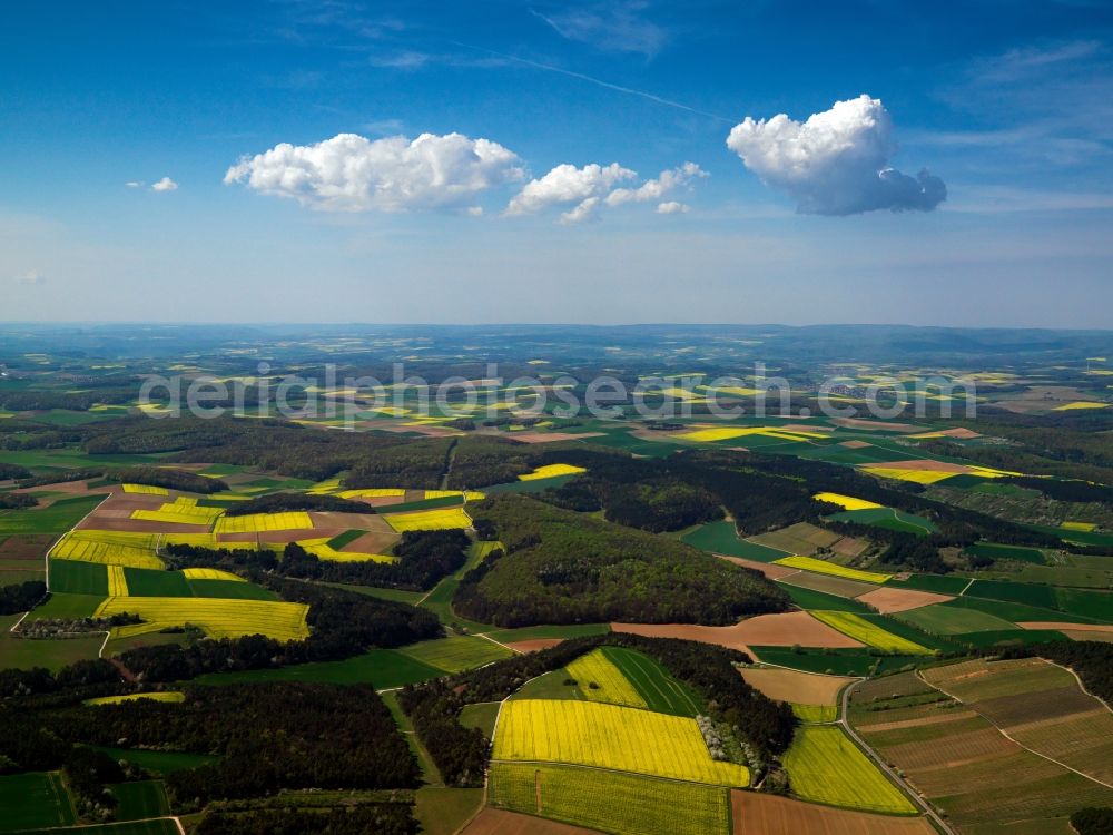 Margetshöchheim from the bird's eye view: Landscape in the west of Margetshoechheim in the state of Bavaria. The region around the borough in the Lower Franconian district of Wuerzburg consists of soft hills, wooded areas and fields - such as the distinct yellow rapeseed fields