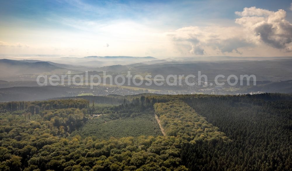 Arnsberg from above - Landscape view over the treetops of a wooded area with view of Arnsberg in the state North Rhine-Westphalia, Germany