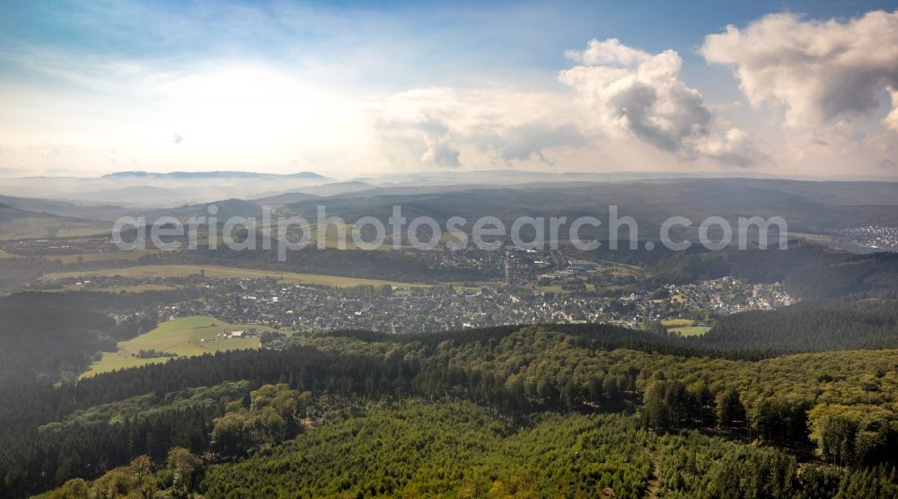 Arnsberg from the bird's eye view: Landscape view over the treetops of a wooded area with view of Arnsberg in the state North Rhine-Westphalia, Germany