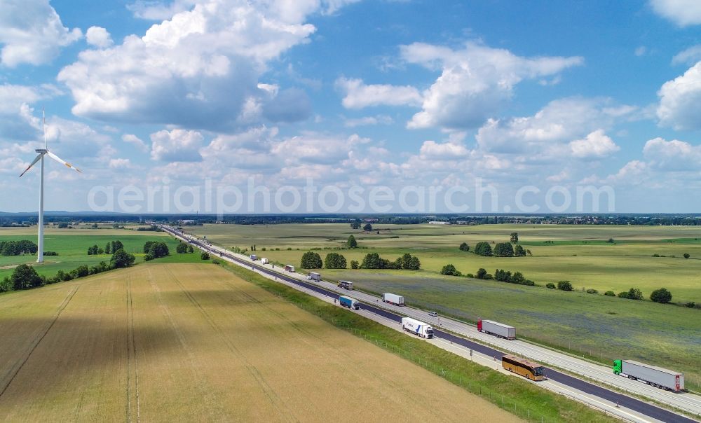 Aerial photograph Biegen - Agricultural fields surround the lanes of the motorway route and the route of the BAB A 12 in Biegen in the state Brandenburg, Germany