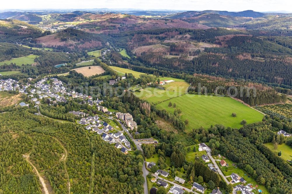 Aerial photograph Brilon - Agricultural land and field borders surround the settlement area of the village in the district Gudenhagen in Brilon in the state North Rhine-Westphalia, Germany