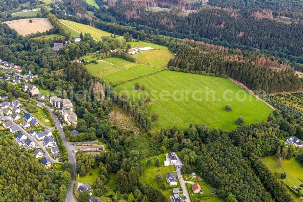 Brilon from above - Agricultural land and field borders surround the settlement area of the village in the district Gudenhagen in Brilon in the state North Rhine-Westphalia, Germany