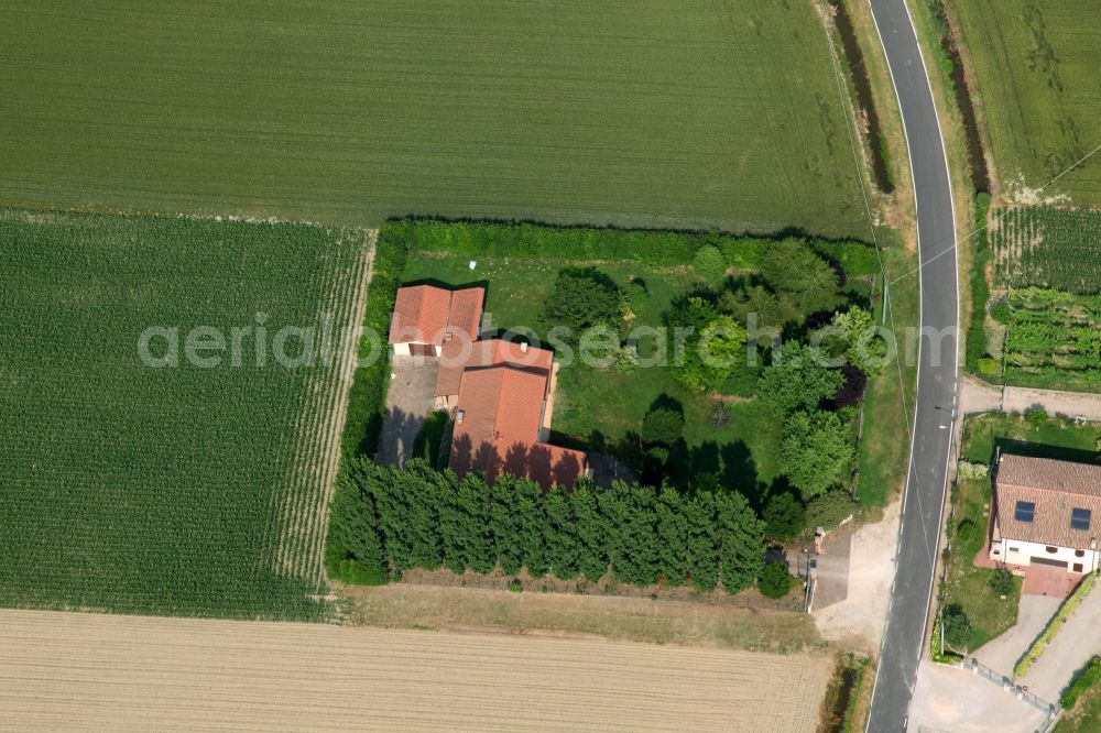 Orti from the bird's eye view: Farm and barn building on the edge of agricultural fields and farmland in Minerbe in Venetien, Italy