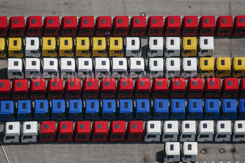 München from the bird's eye view: Truck factory MAN near Karlsfeld in the North of Munich in the state of Bavaria. The differently coloured driver's cabins are standing symmetrically in several rows on the compound of the truck manufacturer MAN in the commercial area of MAN/MTU on the border to Munich